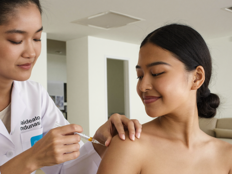 Indonesian woman without hijab receiving vitamin C injection at Skinex clinic